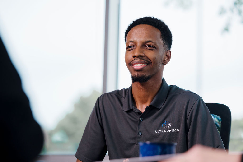 UltraOptics-KnowledgeableCustomerService An Ultra Optics employee sits at a conference table listening to a customer